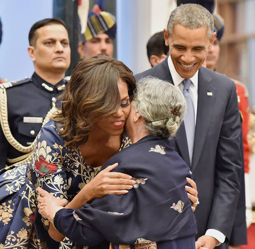  US President Barack Obama looks on as US first Lady Michelle Obama greets ex-PM Mamohan Singhs wife, Gursharan Kaur at a banquet in his honour.