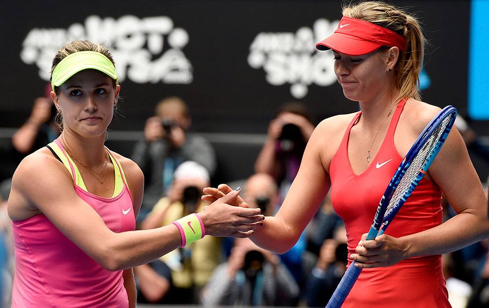 Maria Sharapova of Russia right, is congratulated by Eugenie Bouchard of Canada at the net after winning their quarterfinal match at the Australian Open tennis championship.