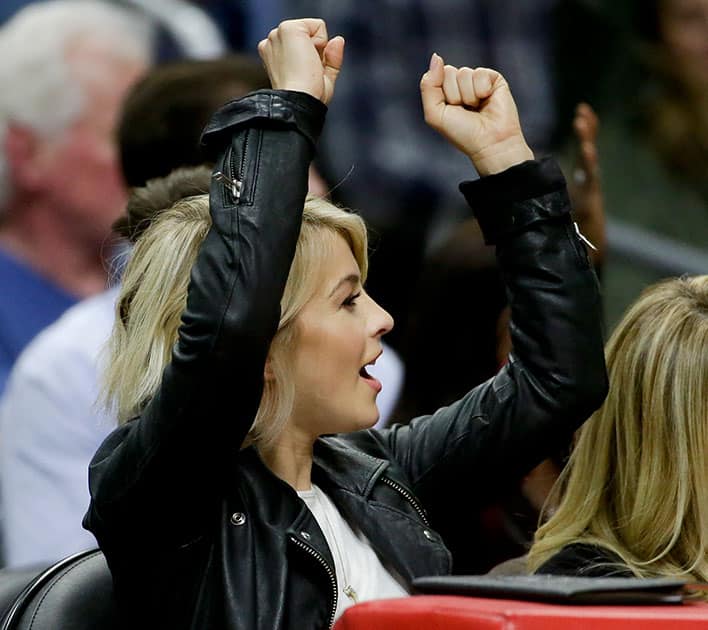 Actress, Julianne Hough watches during the second half of an NBA basketball game between the Los Angeles Clippers and the Denver Nuggets in Los Angeles.