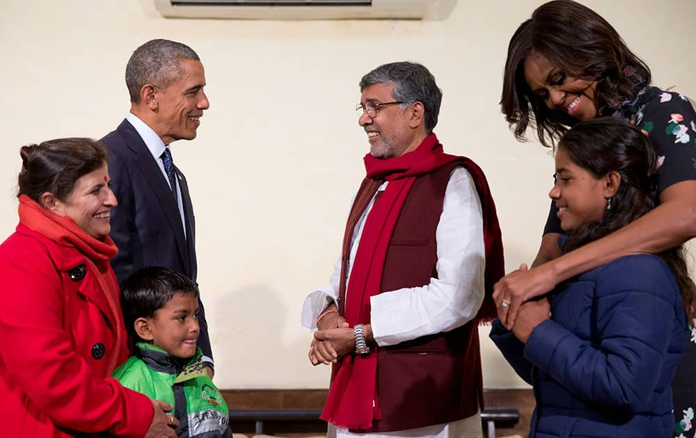 President Barack Obama and first lady Michelle Obama meet with Kailash Satyarthi, third from right, his wife Sumedha Satyarth, left, with Deepak, and Payal Jangid, right, at the Siri Fort Auditorium in New Delhi.