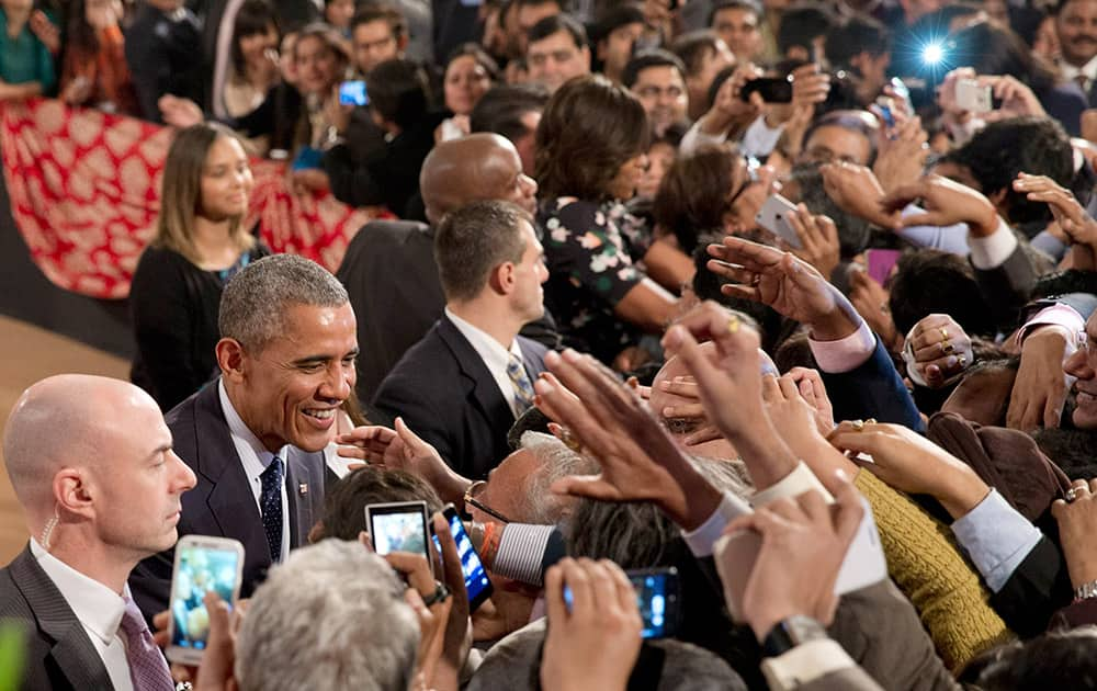 President Barack Obama greets people in the audience after his speech at the Siri Fort Auditorium in New Delhi.