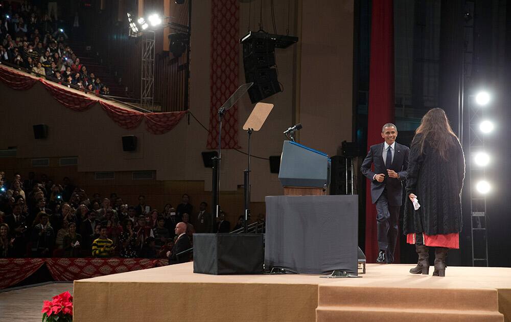 U.S. President Barack Obama jogs onto the stage after being introduced by Pravah CEO Neha Buch, to speak at the Siri Fort Auditorium in New Delhi.