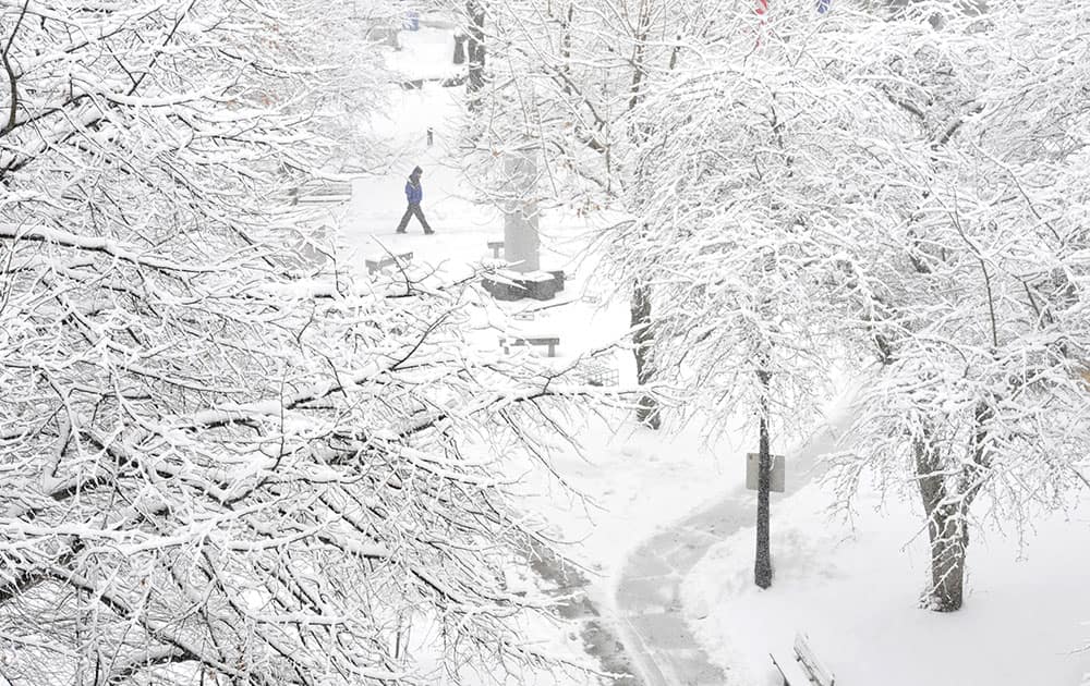 A pedestrian passes through Johnstown Central Park, in Johnstown, Pa. Gov. Tom Wolf declared a state of emergency Monday as a nor’easter expected to dump snow across the state approached.