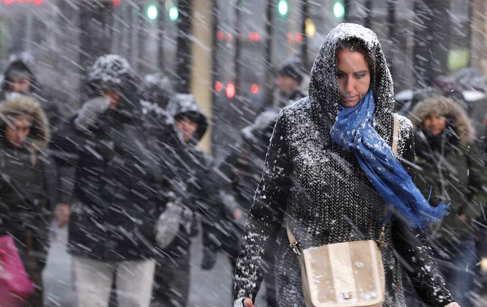 Pedestrians make their way through snow in New York. More than 35 million people along the Philadelphia-to-Boston corridor rushed to get home and settle in Monday as a fearsome storm swirled in with the potential of 1 to 3 feet of snow that could paralyze the Northeast for days.