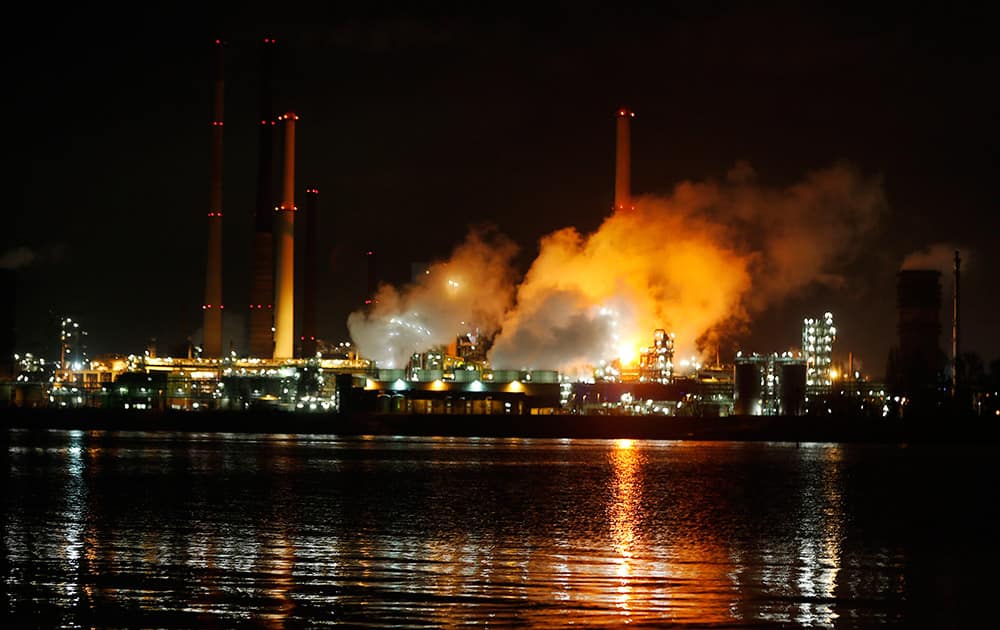 Smoke rises off the illuminated ThyssenKrupp Kokerei Schwelgern steel plant on the river Rhine in Duisburg, Germany.