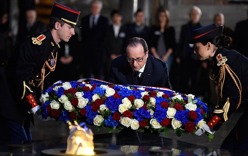 French President Francois Hollande lays a wreath of flowers at the Holocaust memorial in Paris.