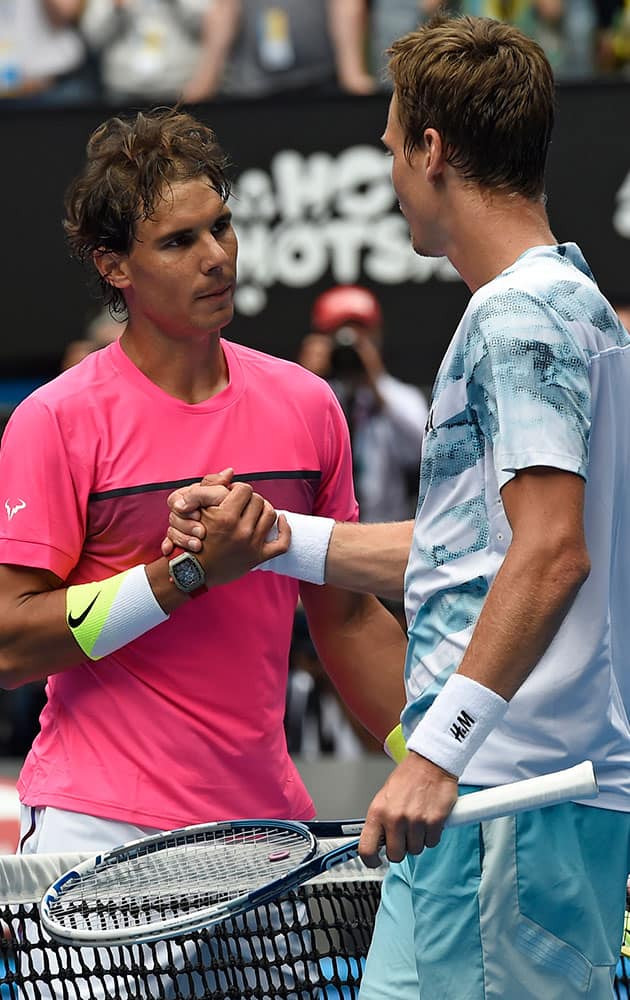 Tomas Berdych of the Czech Republic, right, is congratulated by Rafael Nadal of Spain at the net after winning during their quarterfinal match at the Australian Open tennis championship in Melbourne, Australia.