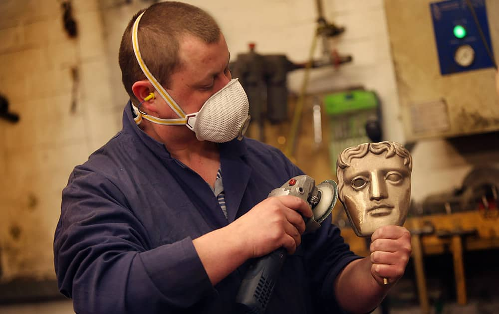 A bronze BAFTA masks is cleaned by a foundryman in West Drayton, England, ahead of the 2015 award ceremony in February.