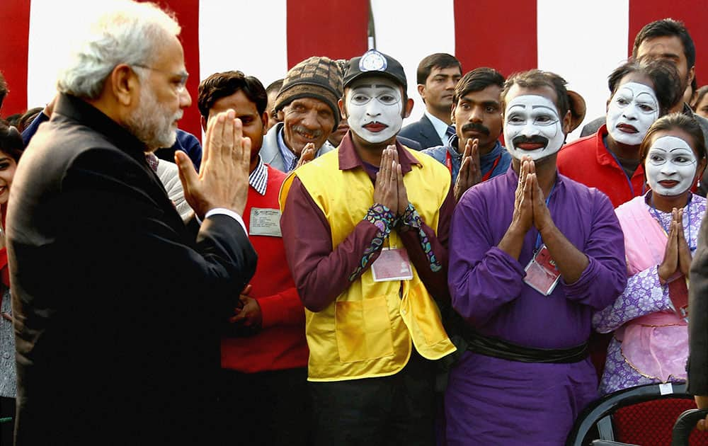 Prime Minister Narendra Modi meets the tableau artists during PMs Tea Party at Teen Murti House in New Delhi.
