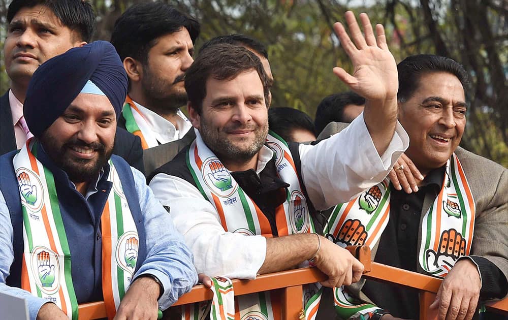 Congress Vice President Rahul Gandhi with Delhi Congress President Arvinder Singh Lovely waves during a road show at Kalkaji for forthcoming Assembly elections in New Delhi.