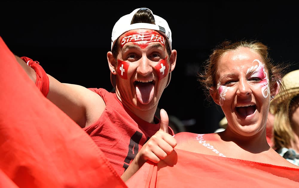 Face painted supporters of Swiss tennis player Stan Wawrinka cheers during his quarterfinal win over Kei Nishikori of Japan at the Australian Open tennis championship.