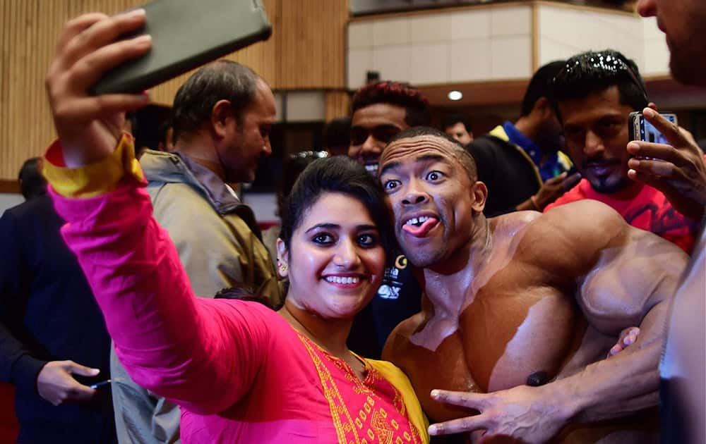 A fan takes selfie with international body builder Ricardo Corriea at the BodyPower Expo 2015 in Bengaluru.