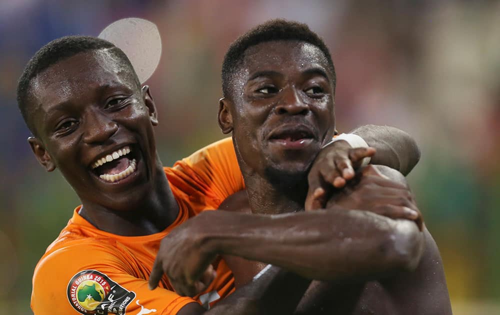 Ivory Coast's Max Alain Gradel, left, and Serge Aurier, right, celebrate, after the African Cup of Nations Group D soccer match between Ivory Coast and Cameroon at Estadio De Malabo in Malabo, Equatorial Guinea.