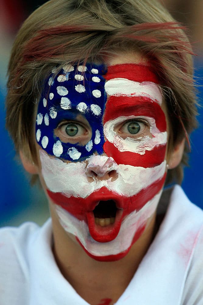 A young fan of the U.S. national soccer team gestures to the camera before the start of a friendly game with Chile in Rancagua, Chile.