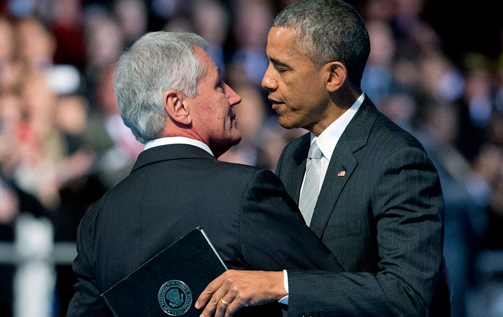 Outgoing Defense Secretary Chuck Hagel, is hugged by President Barack Obama, during the farewell tribute in honor of the secretary of defense, at Joint Base Fort Myer-Henderson Hall in Fort Myer, Va.