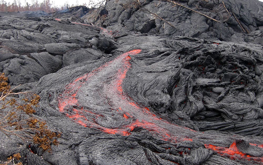 This photo released by the US Geological Survey shows one of many small breakouts of lava on the surface of the June 27 flow immediately upslope of the leading edge near the town of Pahoa on the Big Island of Hawaii. 