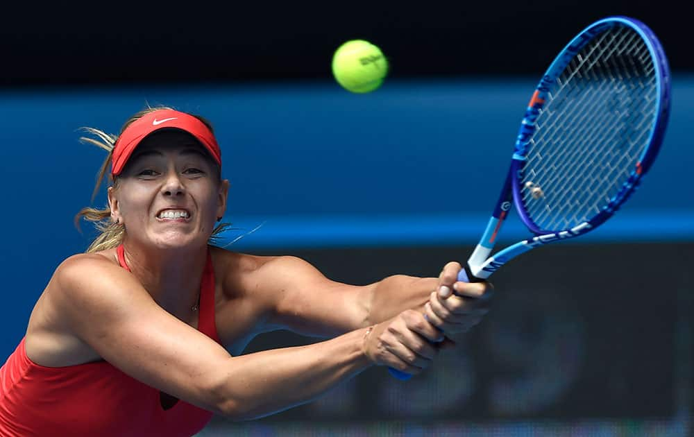 Maria Sharapova of Russia makes a backhand return to her compatriot Ekaterina Makarova during their semifinal match at the Australian Open tennis championship.