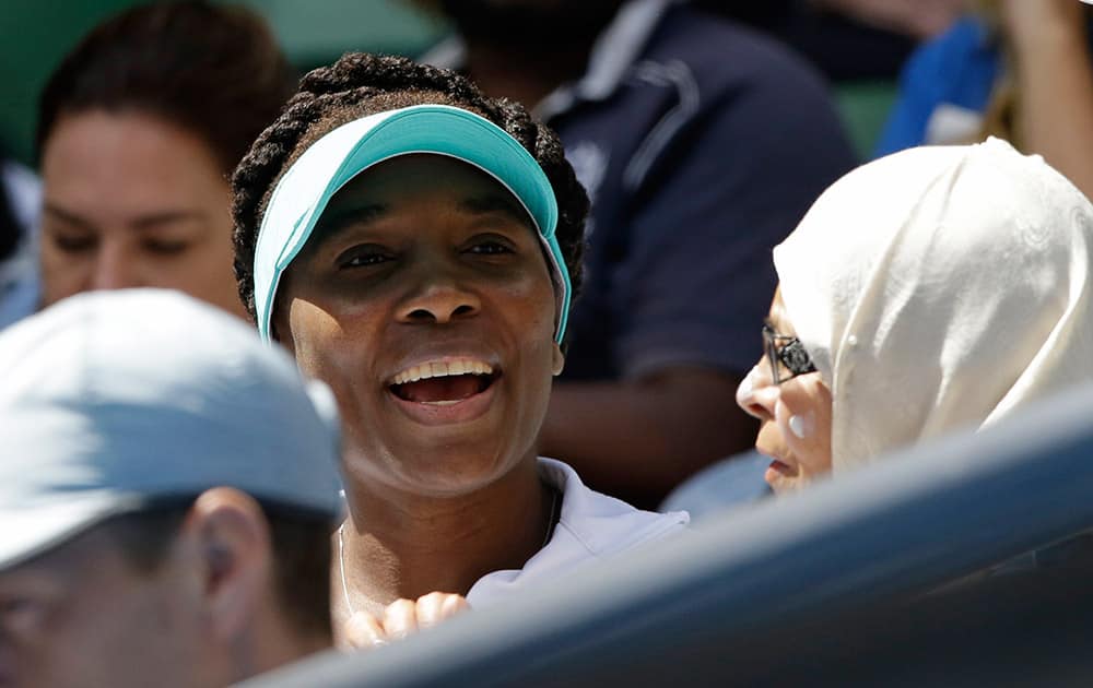 Venus Williams of the U.S., watches her sister Serena Williams' semifinal match against their compatriot Madison Keys at the Australian Open tennis championship in Melbourne, Australia.