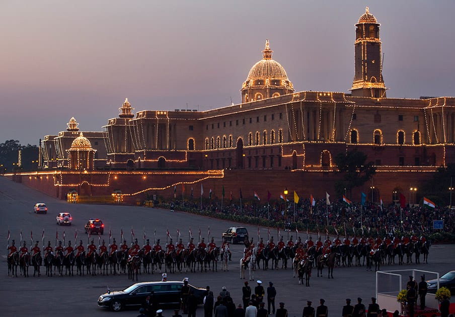 Presidential horse mounted bodyguards stand in a formation as Indian president Pranab Mukherjee, in white box in foreground right, prepares to leave after the Beating Retreat ceremony against illuminated Raisina Hill, which houses India's most important ministries in New Delhi.