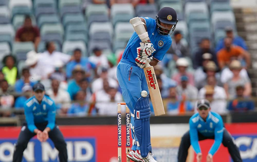 Shikhar Dhawan plays a defensive stroke during their one-day international cricket match against England in Perth, Australia.