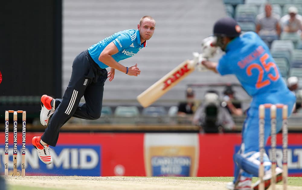 England's Stuart Broad, left, bowls a delivery to India's Shikhar Dhawan during their one-day international cricket match against in Perth, Australia.