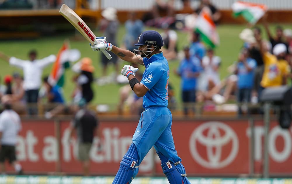 Virat Kohli walks to the crease during their one-day international cricket match against England in Perth.