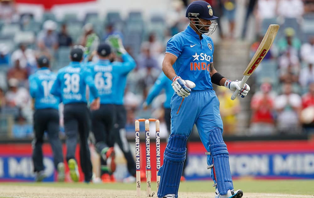 Virat Kohli walks back to the pavilion after losing his wicket for 8 runs during their one-day international cricket match against England in Perth, Australia.