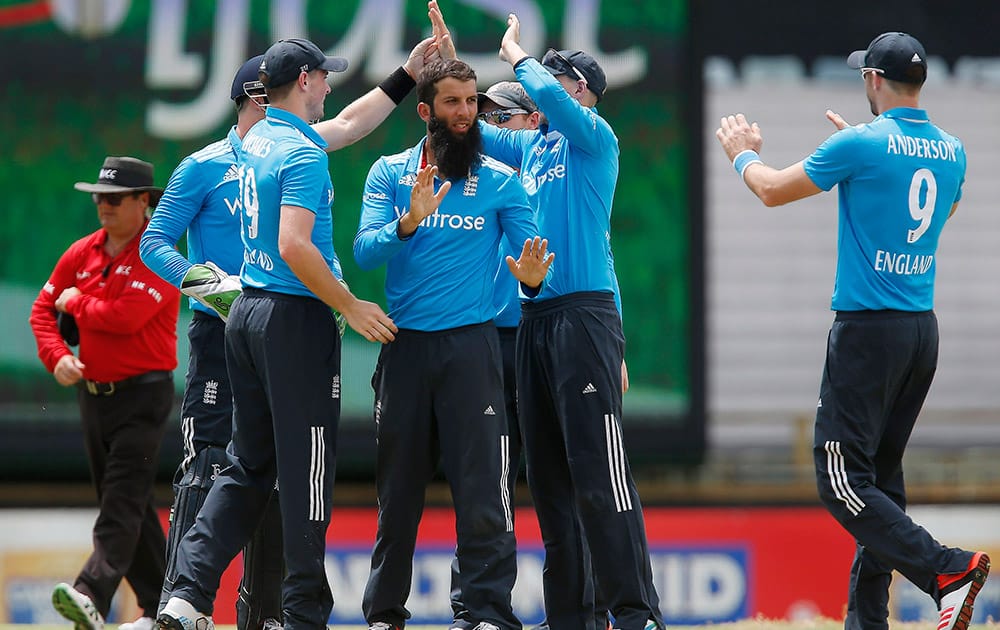 Moeen Ali is congratulated by team mates after taking a wicket during their one-day international cricket match against India in Perth, Australia.