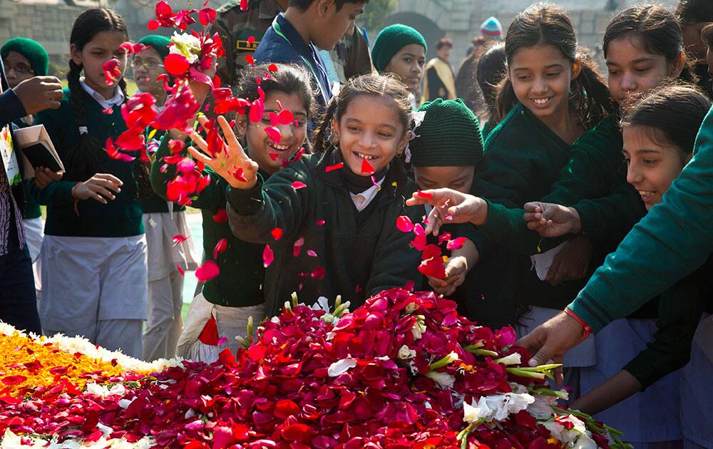 Children throw flowers at Rajghat, a memorial to Mahatma Gandhi, on his death anniversary in New Delhi.