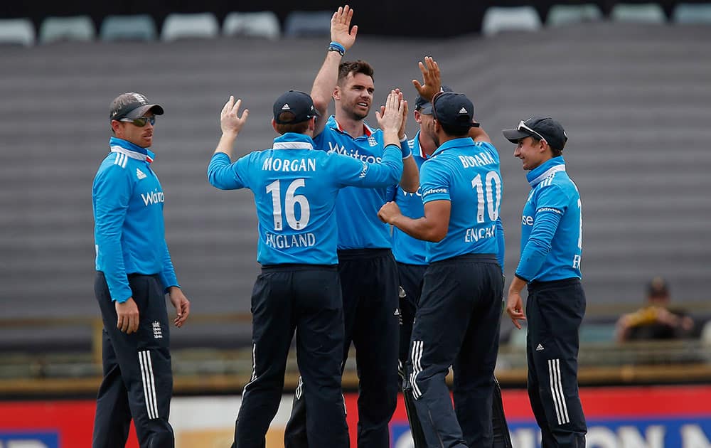 England's James Anderson, is congratulated by teammates after taking a wicket during their one day international cricket match against India in Perth.