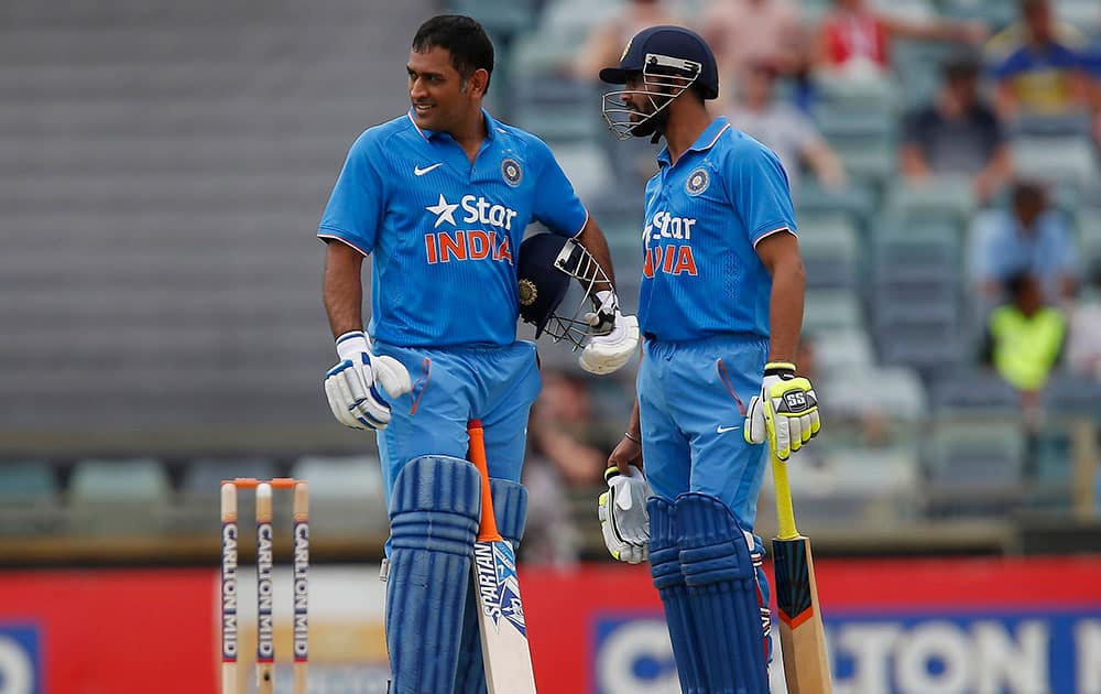 MS Dhoni and team mate Ravindra Jadeja speak during their one-day international cricket match against England in Perth.