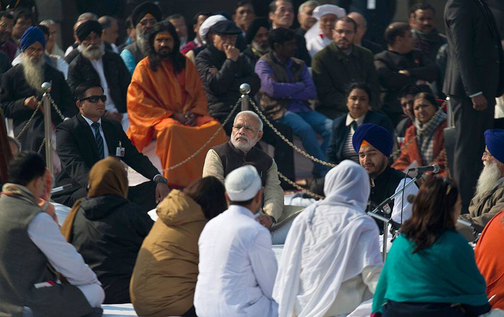 Prime Minister Narendra Modi sits at Rajghat, a memorial to Mahatma Gandhi, on his death anniversary in New Delhi.