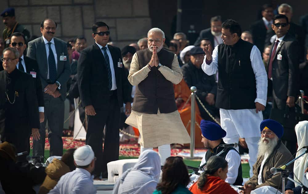 Prime Minister Narendra Modi, greets people at Rajghat, a memorial to Mahatma Gandhi, on his death anniversary in New Delhi.