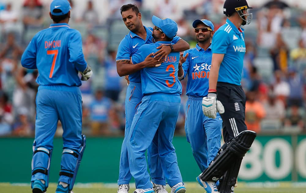 Stuart Binny is congratulated by teammates after taking the wicket of England's Joe Root, during their one day international cricket match in Perth, Australia.