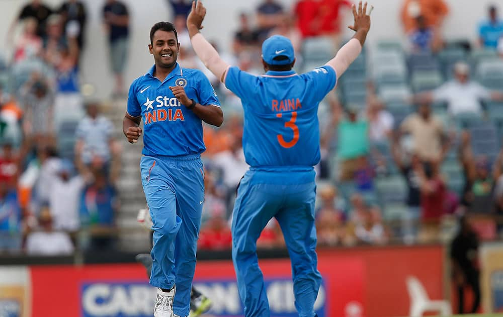 Stuart Binny is congratulated by teammate Suresh Raina after taking the wicket during their one day international cricket match against Englands in Perth, Australia.