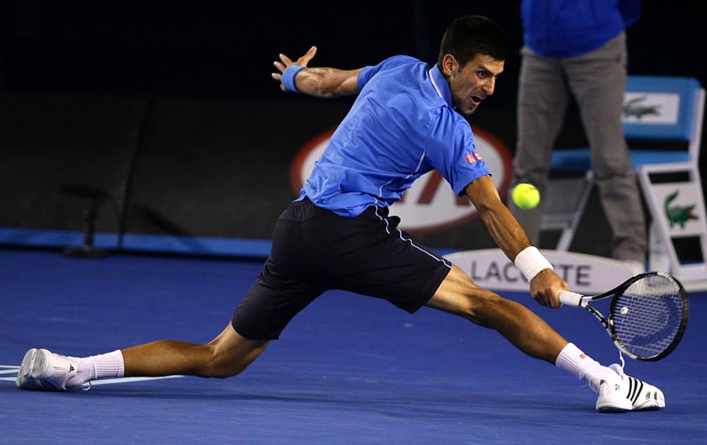 Novak Djokovic of Serbia reaches for a shot to Stan Wawrinka of Switzerland during their semifinal at the Australian Open tennis championship in Melbourne, Australia.