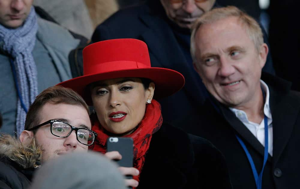 French businessman Francois-Henri Pinault and his wife Mexican-born actress Salma Hayek leave after the French league one soccer match between Paris Saint Germain and Rennes, in Paris, France.