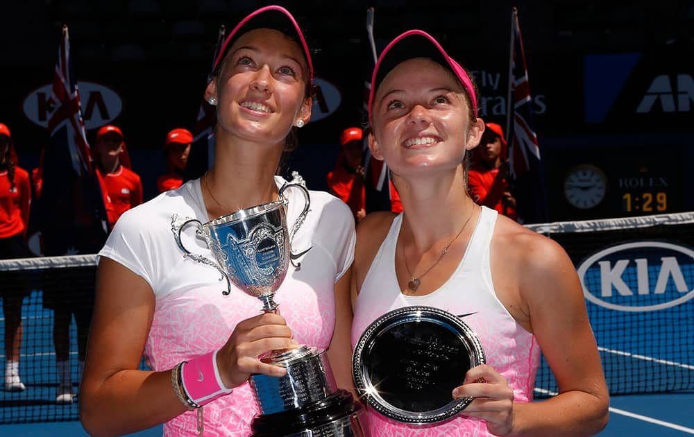 Tereza Mihalikova of Slovakia, holds the trophy with runner-up Katie Swan of Britain after winning the junior girls' singles final at the Australian Open tennis championship in Melbourne, Australia.