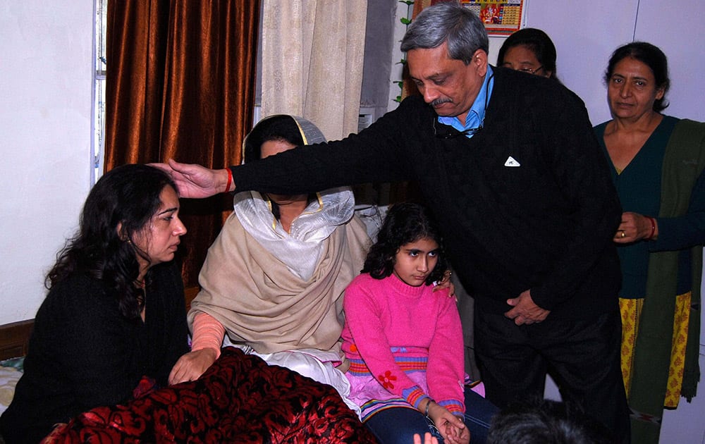 Family members of late Col Munindra Nath Rai being console by Defence Minister Manohar Parikar as he came to meet at their home in New Delhi.