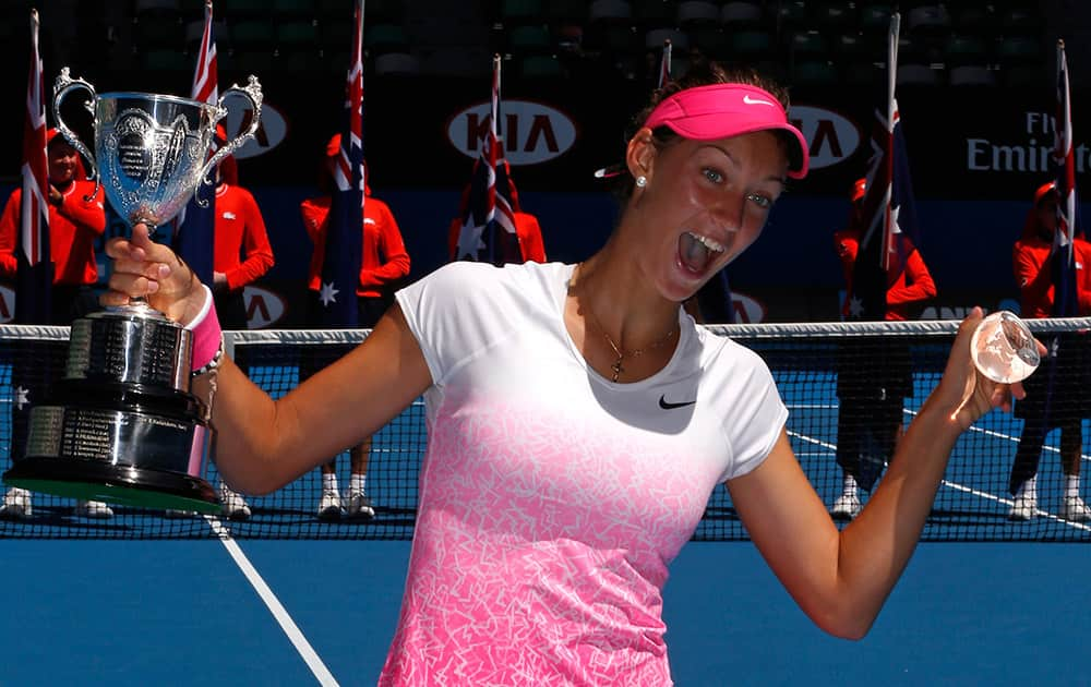 Tereza Mihalikova of Slovakia holds the trophy after winning over Katie Swan of Britain in the junior girls' singles final at the Australian Open tennis championship in Melbourne, Australia.