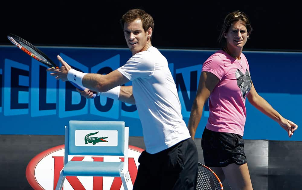 Andy Murray of Britain practices as his coach Amelie Mauresmo looks on ahead of the men's singles final at the Australian Open tennis championship in Melbourne, Australia. Murray will play Novak Djokovic of Serbia in Sunday's final.