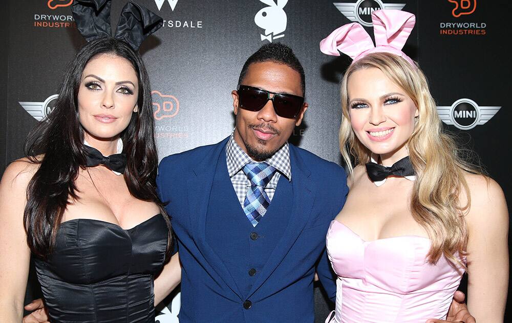 Nick Cannon poses with Playboy Playmates on arrival at the Playboy Super Bowl XLIX Party in Scottsdale, Ariz.