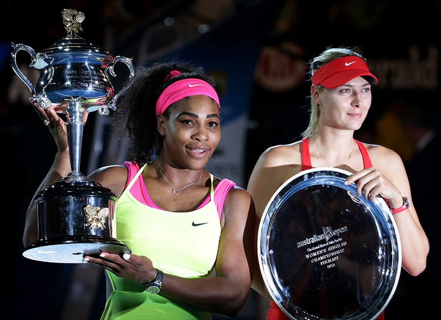 Serena Williams of the US, holds the trophy with runner-up Maria Sharapova of Russia after winning the women's singles final at the Australian Open tennis championship in Melbourne, Australia.