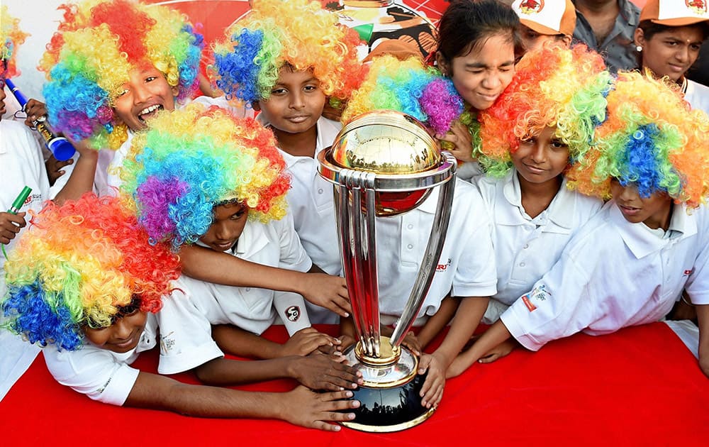 Children pose with ICC World Cup 2015 Trophy at Marina beach in Chennai.