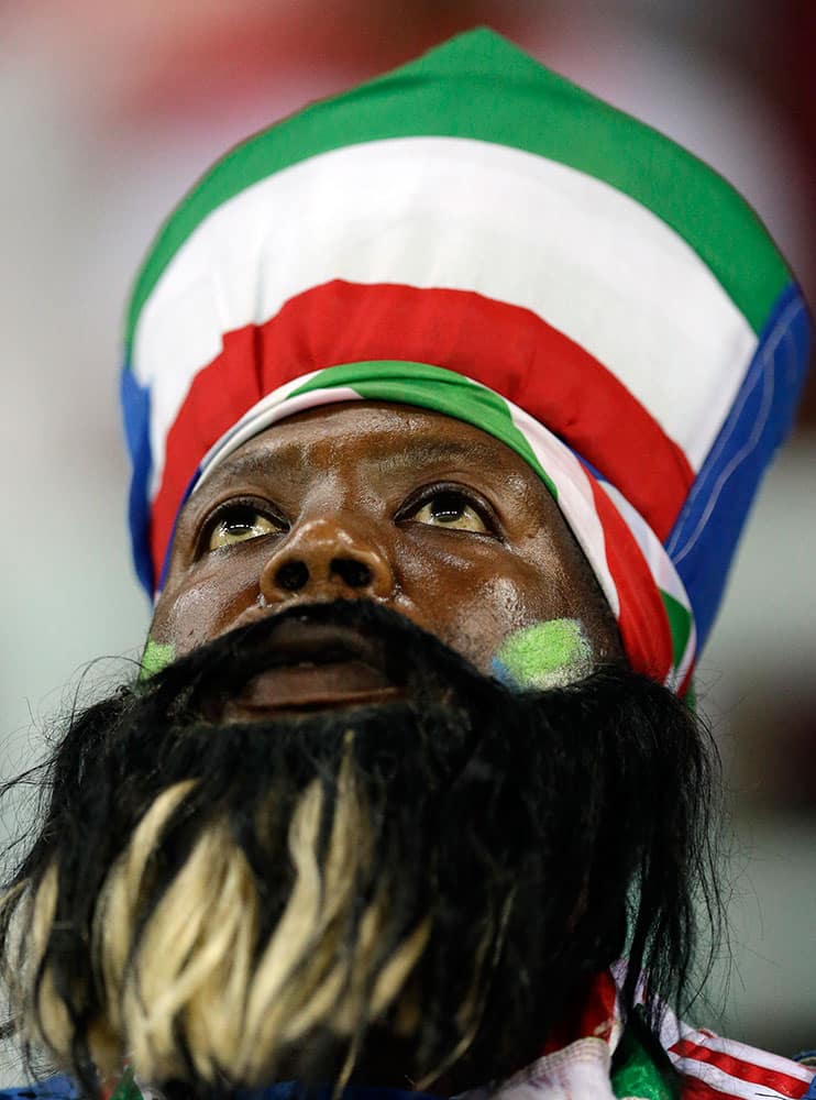 An Equatorial Guinea soccer fan watches during the African Cup of Nations quarter final soccer match between Equatorial Guinea and Tunisia in Bata, Equatorial Guinea.