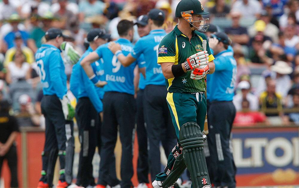 Australia's Dave Warner walks back to the pavilion after losing his wicket during their one-day international cricket match against England in Perth, Australia.