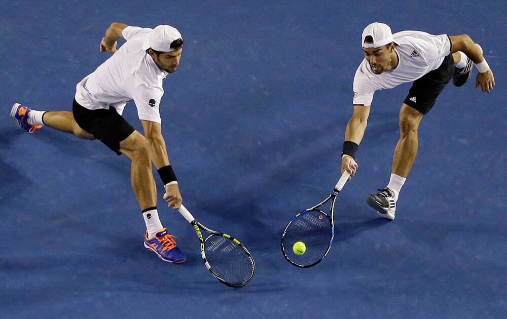 Italy’s Simone Bolelli, right, and Fabio Fognini, play a shot to France’s Pierre-Hugues Herbert and Nicolas Mahut during the men's doubles final at the Australian Open tennis championship in Melbourne, Australia.