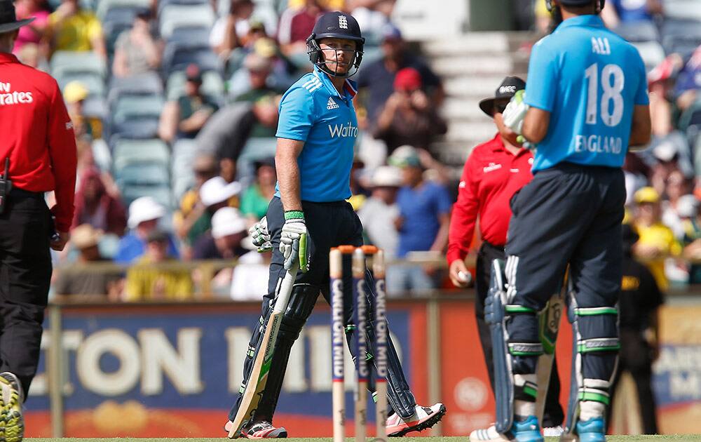 England's Ian Bell, center, walks back to the pavilion after being caught behind for 8 runs during their one day international cricket match against Australia in Perth, Australia, Sunday.