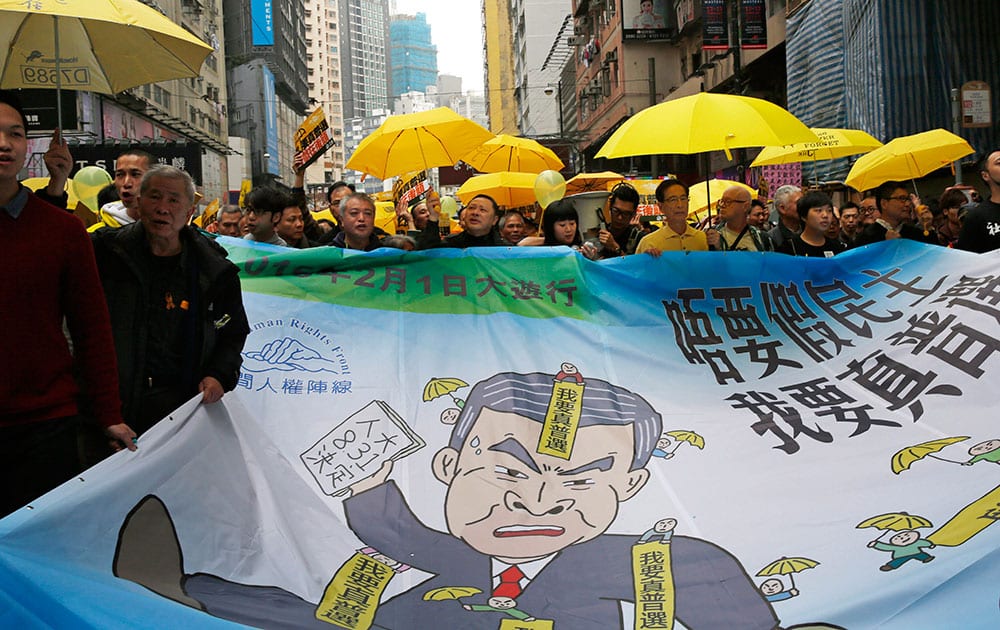 Pro-democracy activists carry a banner depicting Hong Kong Chief Executive Leung Chun-ying during a march to Central, demanding for universal suffrage in Hong Kong.