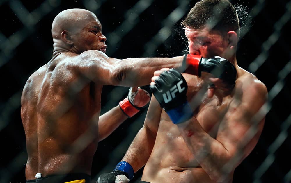 Middleweight Anderson Silva draws a fist across the face of Nick Diaz during their fight at the MGM Grand Garden Arena in Las Vegas.